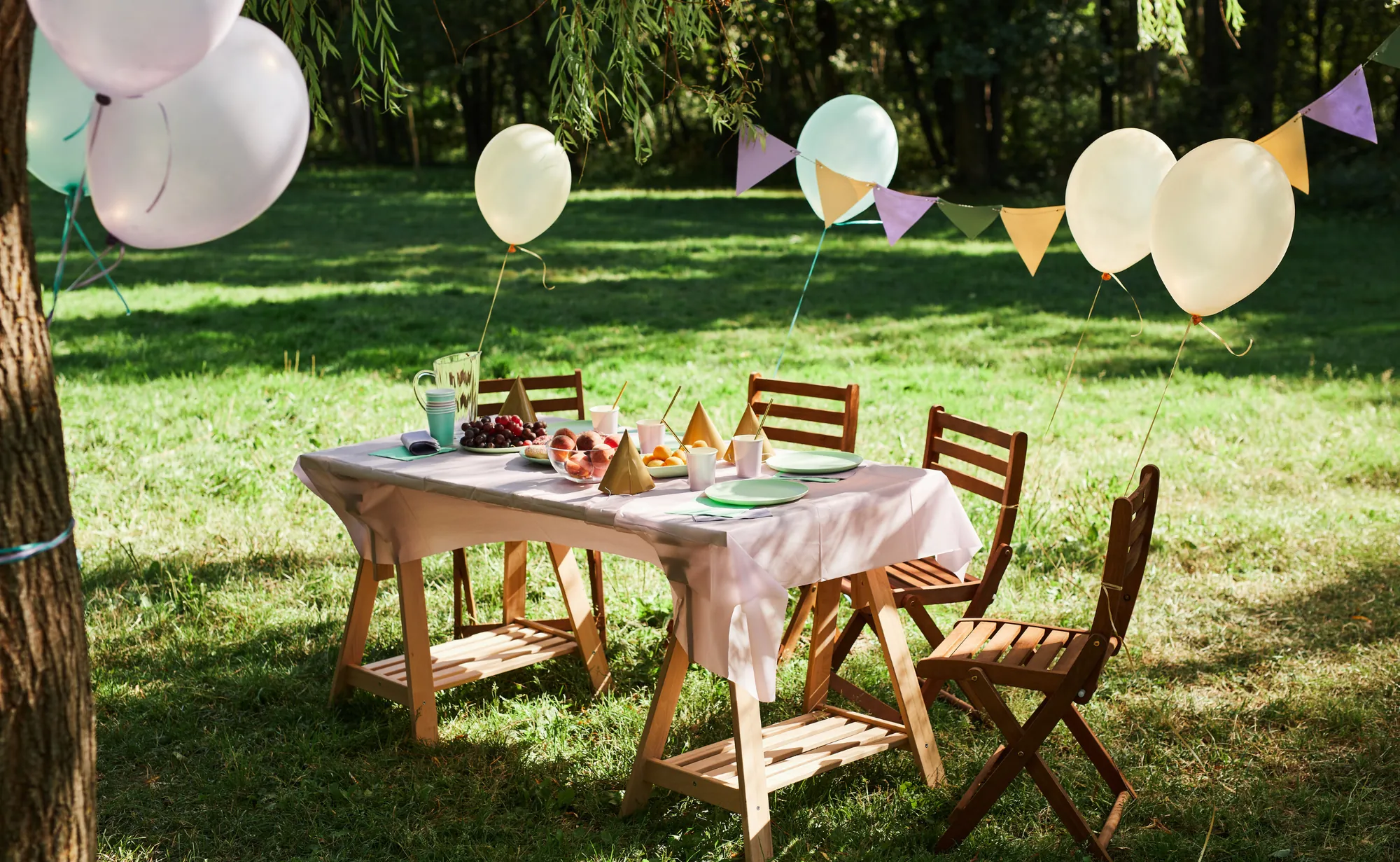 Garden birthday table with balloons and bunting