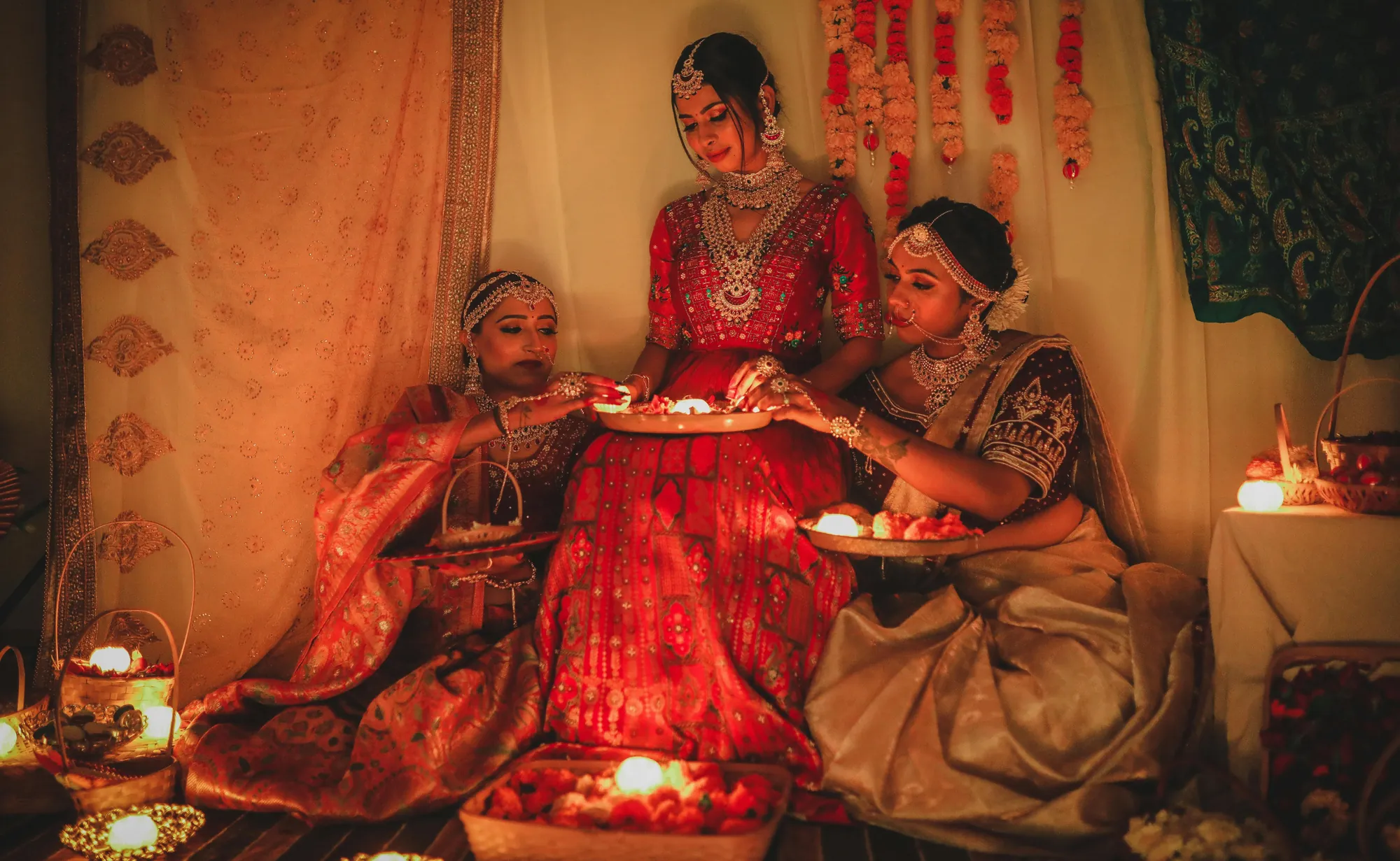 Bridal-wear campaign: three women with glowing diyas