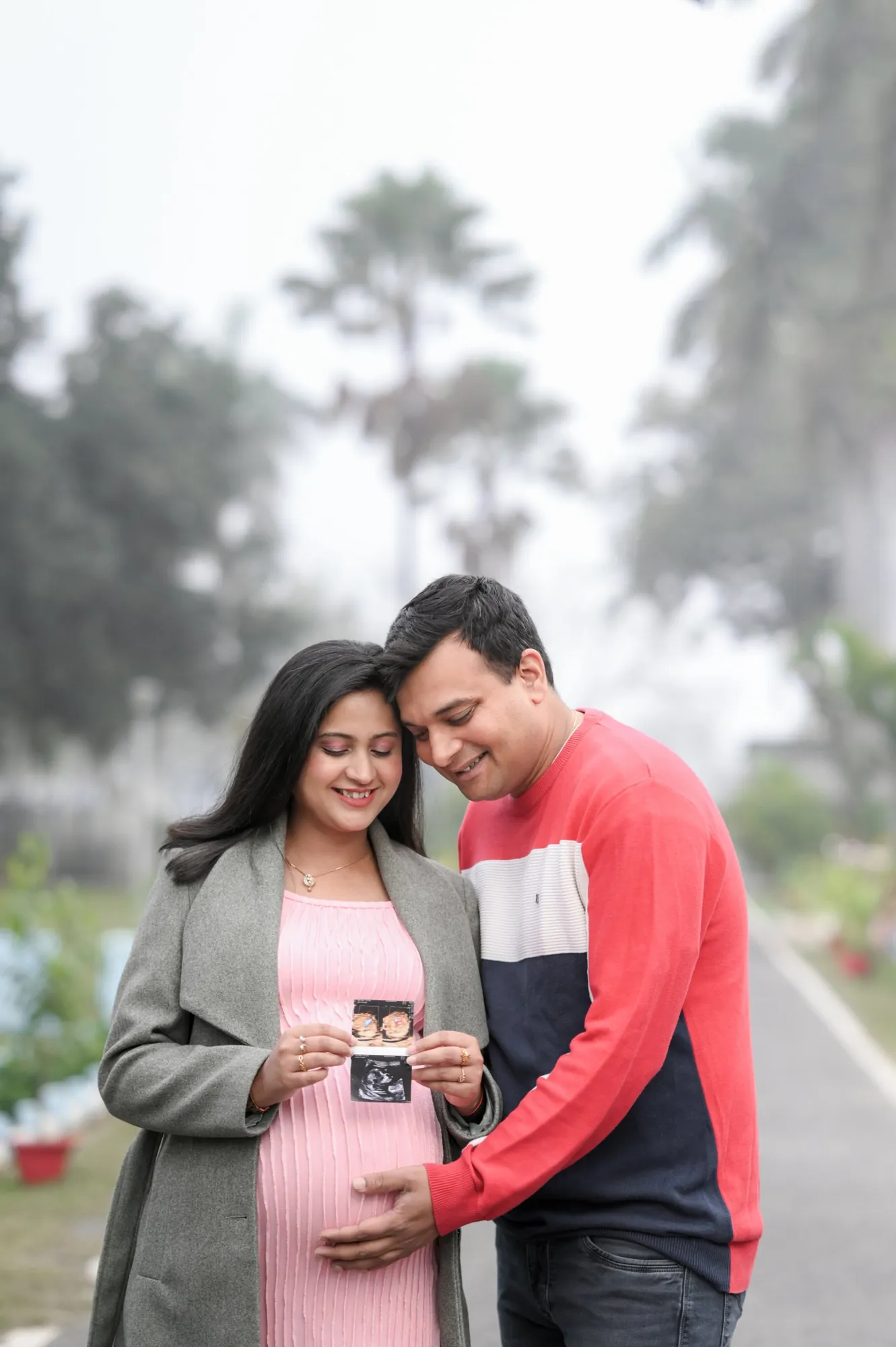 Expecting couple holding their baby's sonogram